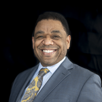 William Redd Smiling in a Suit